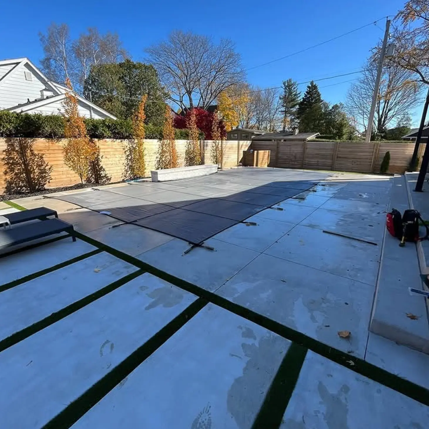 A backyard with a covered pool